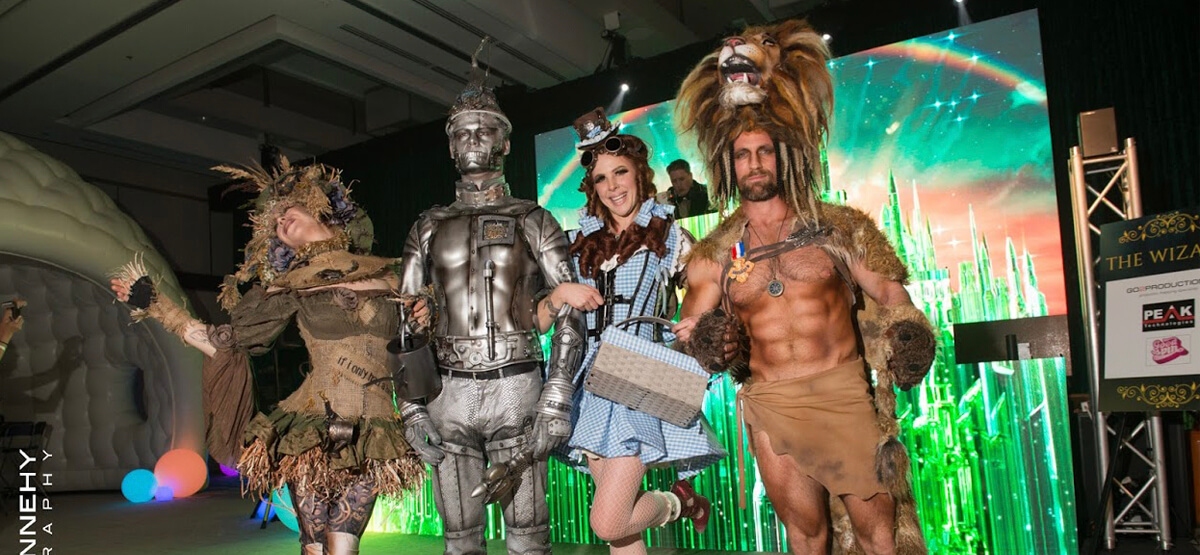 Party revelers in costume LED DJ Booth